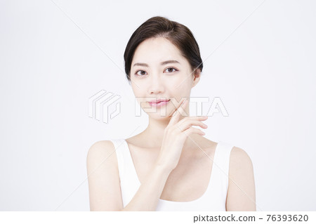beatiful Asian woman with white sleeveless, white background shot with beauty cosmetics concept beatiful Asian woman with white sleeveless, white background shot with beauty cosmetics concept 76393620