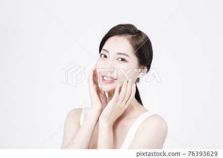 beatiful Asian woman with white sleeveless, white background shot with beauty cosmetics concept beatiful Asian woman with white sleeveless, white background shot with beauty cosmetics concept 76393629