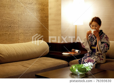 A woman in a relaxing yukata A woman in a relaxing yukata 76393630