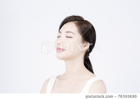 beatiful Asian woman with white sleeveless, white background shot with beauty cosmetics concept beatiful Asian woman with white sleeveless, white background shot with beauty cosmetics concept 76393690