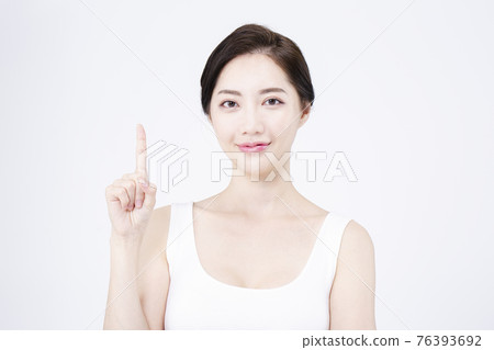 beatiful Asian woman with white sleeveless, white background shot with beauty cosmetics concept beatiful Asian woman with white sleeveless, white background shot with beauty cosmetics concept 76393692