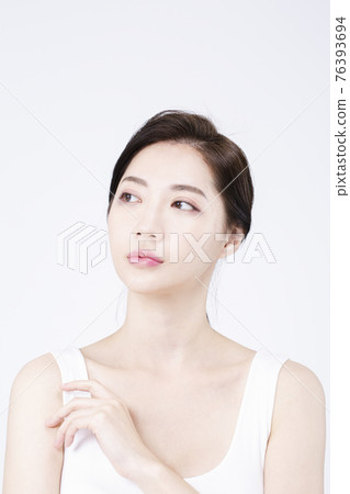 beatiful Asian woman with white sleeveless, white background shot with beauty cosmetics concept beatiful Asian woman with white sleeveless, white background shot with beauty cosmetics concept 76393694