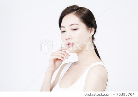 beatiful Asian woman with white sleeveless, white background shot with beauty cosmetics concept beatiful Asian woman with white sleeveless, white background shot with beauty cosmetics concept 76393704