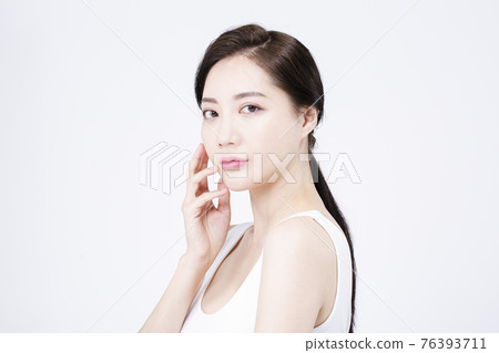 beatiful Asian woman with white sleeveless, white background shot with beauty cosmetics concept beatiful Asian woman with white sleeveless, white background shot with beauty cosmetics concept 76393711