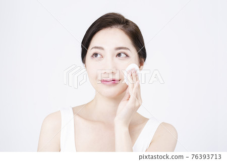 beatiful Asian woman with white sleeveless, white background shot with beauty cosmetics concept beatiful Asian woman with white sleeveless, white background shot with beauty cosmetics concept 76393713