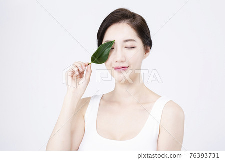 beatiful Asian woman with white sleeveless, white background shot with beauty cosmetics concept beatiful Asian woman with white sleeveless, white background shot with beauty cosmetics concept 76393731