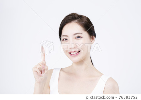 beatiful Asian woman with white sleeveless, white background shot with beauty cosmetics concept beatiful Asian woman with white sleeveless, white background shot with beauty cosmetics concept 76393752