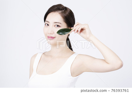 beatiful Asian woman with white sleeveless, white background shot with beauty cosmetics concept beatiful Asian woman with white sleeveless, white background shot with beauty cosmetics concept 76393761