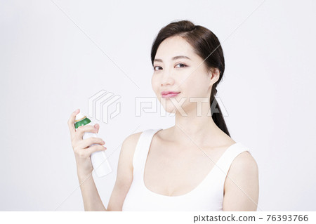 beatiful Asian woman with white sleeveless, white background shot with beauty cosmetics concept beatiful Asian woman with white sleeveless, white background shot with beauty cosmetics concept 76393766