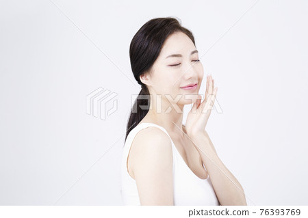 beatiful Asian woman with white sleeveless, white background shot with beauty cosmetics concept beatiful Asian woman with white sleeveless, white background shot with beauty cosmetics concept 76393769
