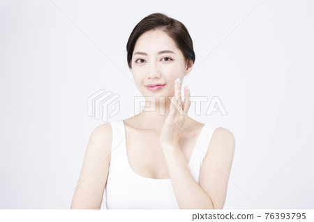 beatiful Asian woman with white sleeveless, white background shot with beauty cosmetics concept beatiful Asian woman with white sleeveless, white background shot with beauty cosmetics concept 76393795