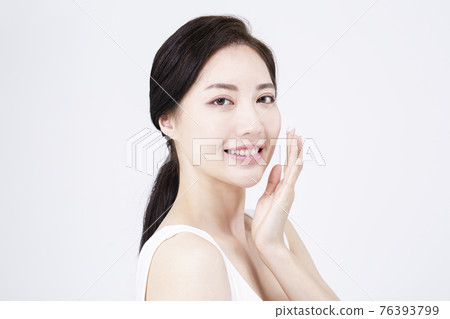 beatiful Asian woman with white sleeveless, white background shot with beauty cosmetics concept beatiful Asian woman with white sleeveless, white background shot with beauty cosmetics concept 76393799