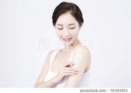 beatiful Asian woman with white sleeveless, white background shot with beauty cosmetics concept beatiful Asian woman with white sleeveless, white background shot with beauty cosmetics concept 76393801