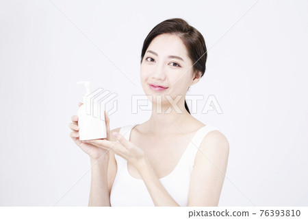 beatiful Asian woman with white sleeveless, white background shot with beauty cosmetics concept beatiful Asian woman with white sleeveless, white background shot with beauty cosmetics concept 76393810