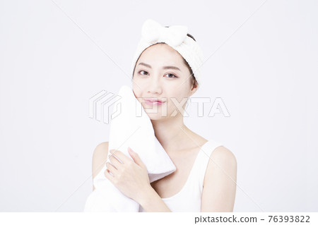 beatiful Asian woman with white sleeveless, white background shot with beauty cosmetics concept beatiful Asian woman with white sleeveless, white background shot with beauty cosmetics concept 76393822