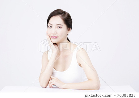 beatiful Asian woman with white sleeveless, white background shot with beauty cosmetics concept beatiful Asian woman with white sleeveless, white background shot with beauty cosmetics concept 76393825