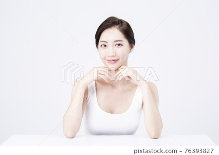 beatiful Asian woman with white sleeveless, white background shot with beauty cosmetics concept 76393827
