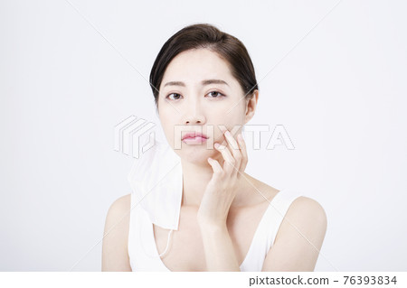 beatiful Asian woman with white sleeveless, white background shot with beauty cosmetics concept beatiful Asian woman with white sleeveless, white background shot with beauty cosmetics concept 76393834