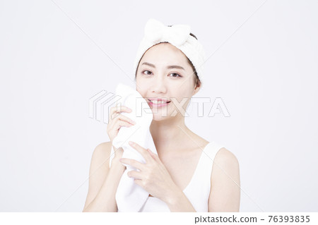 beatiful Asian woman with white sleeveless, white background shot with beauty cosmetics concept beatiful Asian woman with white sleeveless, white background shot with beauty cosmetics concept 76393835