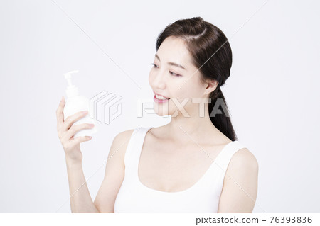 beatiful Asian woman with white sleeveless, white background shot with beauty cosmetics concept beatiful Asian woman with white sleeveless, white background shot with beauty cosmetics concept 76393836