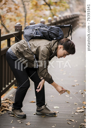 Asian handsome man trekking, climbing autumn mountain Asian handsome man trekking, climbing autumn mountain 76393841