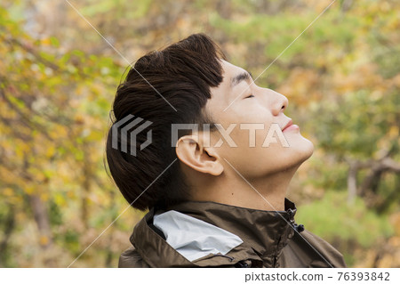 Asian handsome man trekking, climbing autumn mountain Asian handsome man trekking, climbing autumn mountain 76393842