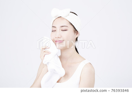 beatiful Asian woman with white sleeveless, white background shot with beauty cosmetics concept beatiful Asian woman with white sleeveless, white background shot with beauty cosmetics concept 76393846