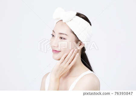 beatiful Asian woman with white sleeveless, white background shot with beauty cosmetics concept beatiful Asian woman with white sleeveless, white background shot with beauty cosmetics concept 76393847