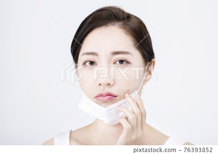beatiful Asian woman with white sleeveless, white background shot with beauty cosmetics concept beatiful Asian woman with white sleeveless, white background shot with beauty cosmetics concept 76393852