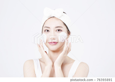beatiful Asian woman with white sleeveless, white background shot with beauty cosmetics concept beatiful Asian woman with white sleeveless, white background shot with beauty cosmetics concept 76393891