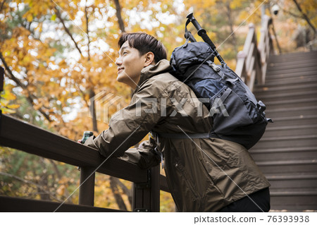 Asian handsome man trekking, climbing autumn mountain Asian handsome man trekking, climbing autumn mountain 76393938
