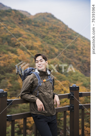 Asian handsome man trekking, climbing autumn mountain Asian handsome man trekking, climbing autumn mountain 76393964