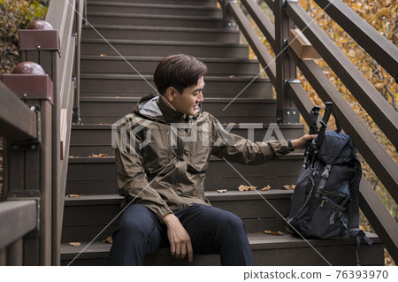 Asian handsome man trekking, climbing autumn mountain Asian handsome man trekking, climbing autumn mountain 76393970
