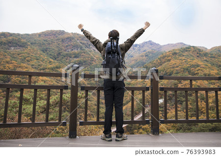 Asian handsome man trekking, climbing autumn mountain Asian handsome man trekking, climbing autumn mountain 76393983