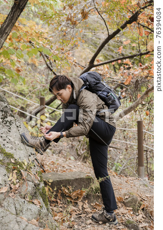 Asian handsome man trekking, climbing autumn mountain Asian handsome man trekking, climbing autumn mountain 76394084