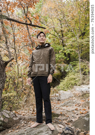 Asian handsome man trekking, climbing autumn mountain Asian handsome man trekking, climbing autumn mountain 76394085