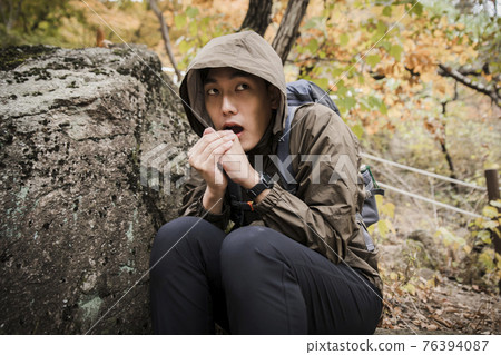 Asian handsome man trekking, climbing autumn mountain Asian handsome man trekking, climbing autumn mountain 76394087