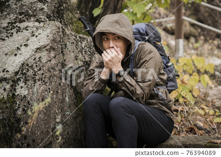 Asian handsome man trekking, climbing autumn mountain Asian handsome man trekking, climbing autumn mountain 76394089