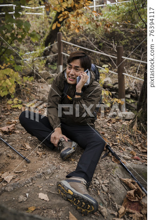 Asian handsome man trekking, climbing autumn mountain Asian handsome man trekking, climbing autumn mountain 76394117