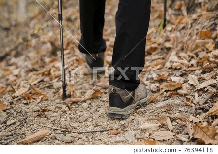 Asian handsome man trekking, climbing autumn mountain Asian handsome man trekking, climbing autumn mountain 76394118