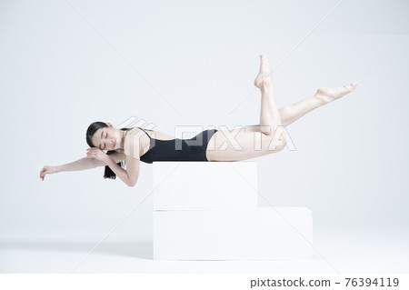 contemporary Asian female dancer making move in white background contemporary Asian female dancer making move in white background 76394119