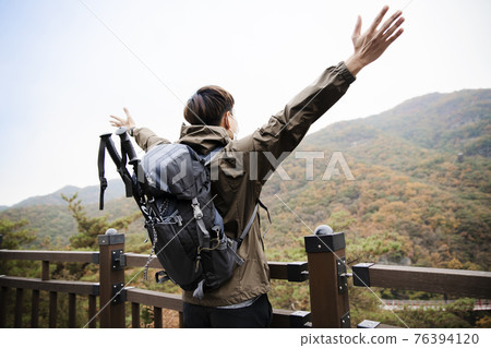 Asian handsome man with mask trekking, climbing autumn mountain Asian handsome man with mask trekking, climbing autumn mountain 76394120