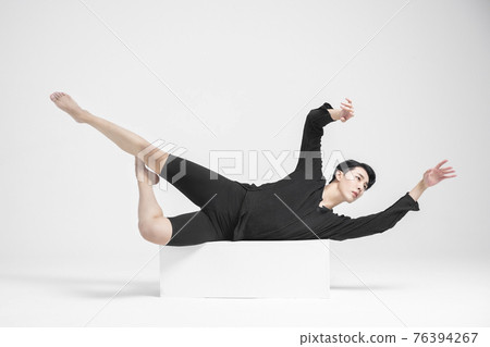 contemporary asian male dancer making move in white background 76394267