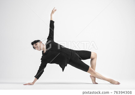 contemporary asian male dancer making move in white background contemporary asian male dancer making move in white background 76394308