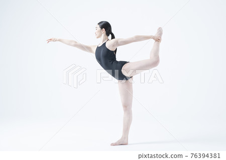 contemporary Asian female dancer making move in white background 76394381