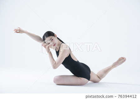 contemporary Asian female dancer making move in white background 76394412