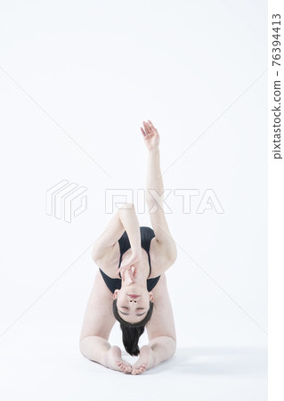 contemporary Asian female dancer making move in white background 76394413