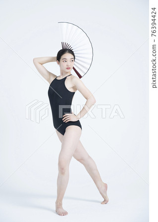 contemporary Asian female dancer making move in white background contemporary Asian female dancer making move in white background 76394424