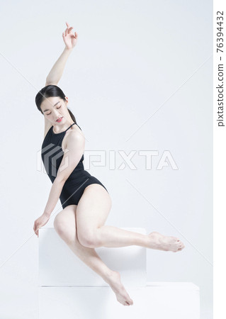 contemporary Asian female dancer making move in white background contemporary Asian female dancer making move in white background 76394432