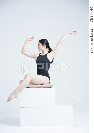 contemporary Asian female dancer making move in white background contemporary Asian female dancer making move in white background 76394442